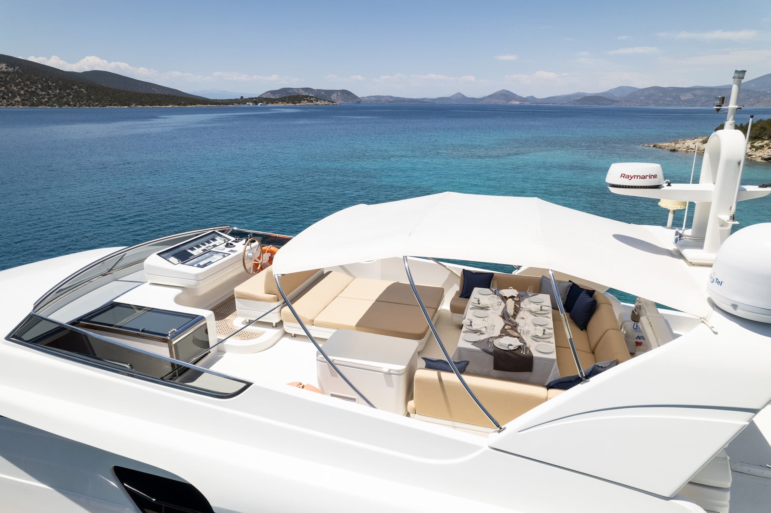 ALEGRIA - flybridge helm station and seating overlooking the sea | Drivas Yachts