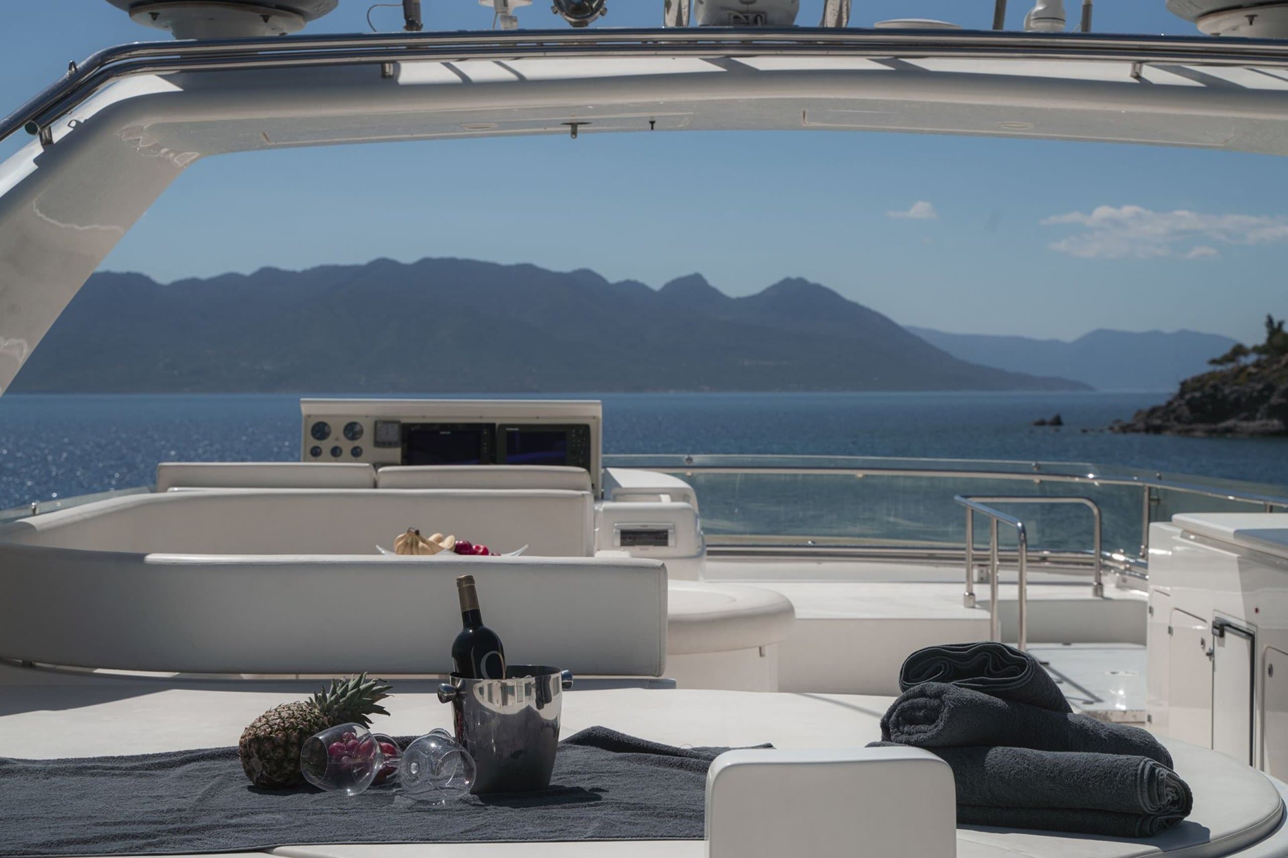 LIDIA - flybridge lounge and wet bar with fruit, champagne and mountain sea view | Drivas Yachts