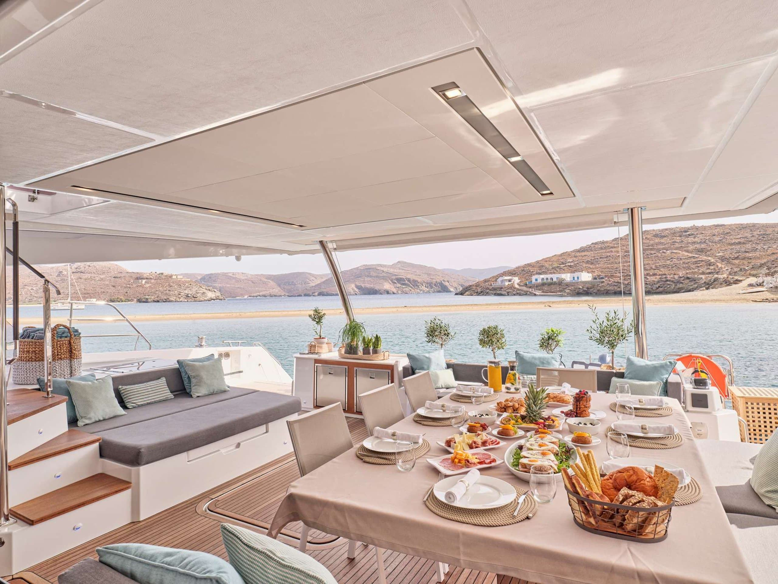 DOLLY - aft deck dining table with breakfast spread and sea view | Drivas Yachts
