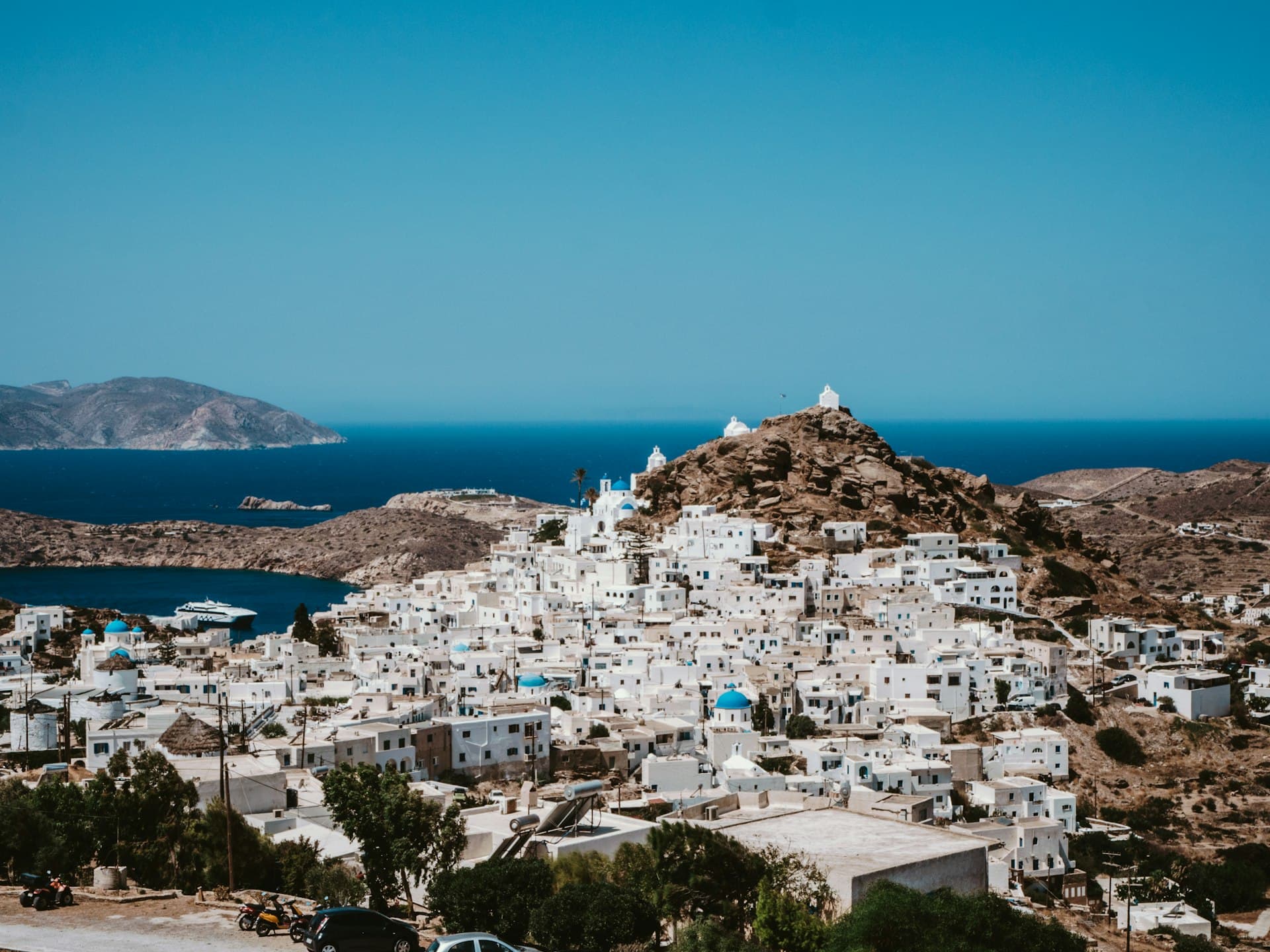 Whitewashed houses of Ios Chora cascading down to the harbour