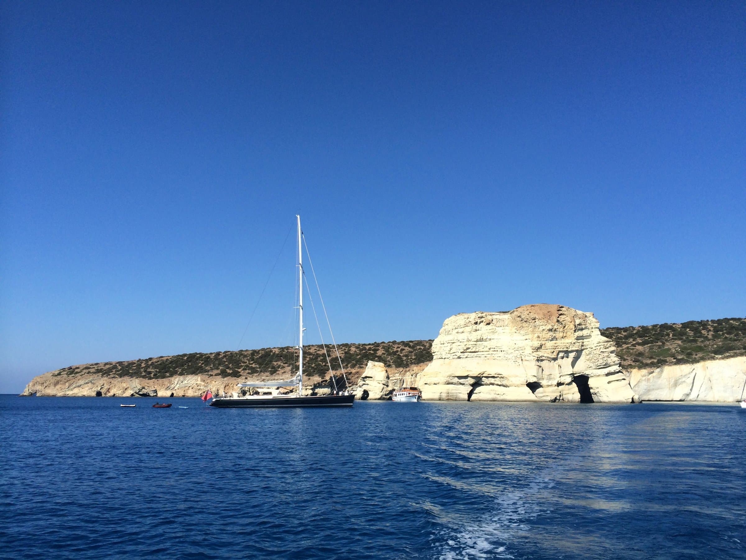 A sailing yacht anchored under the white cliffs of Kleftiko, Milos