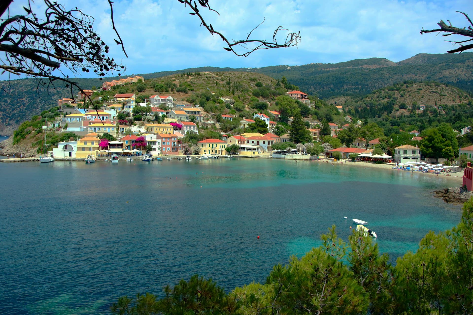 Poros clock tower and the colourful waterfront from the sea