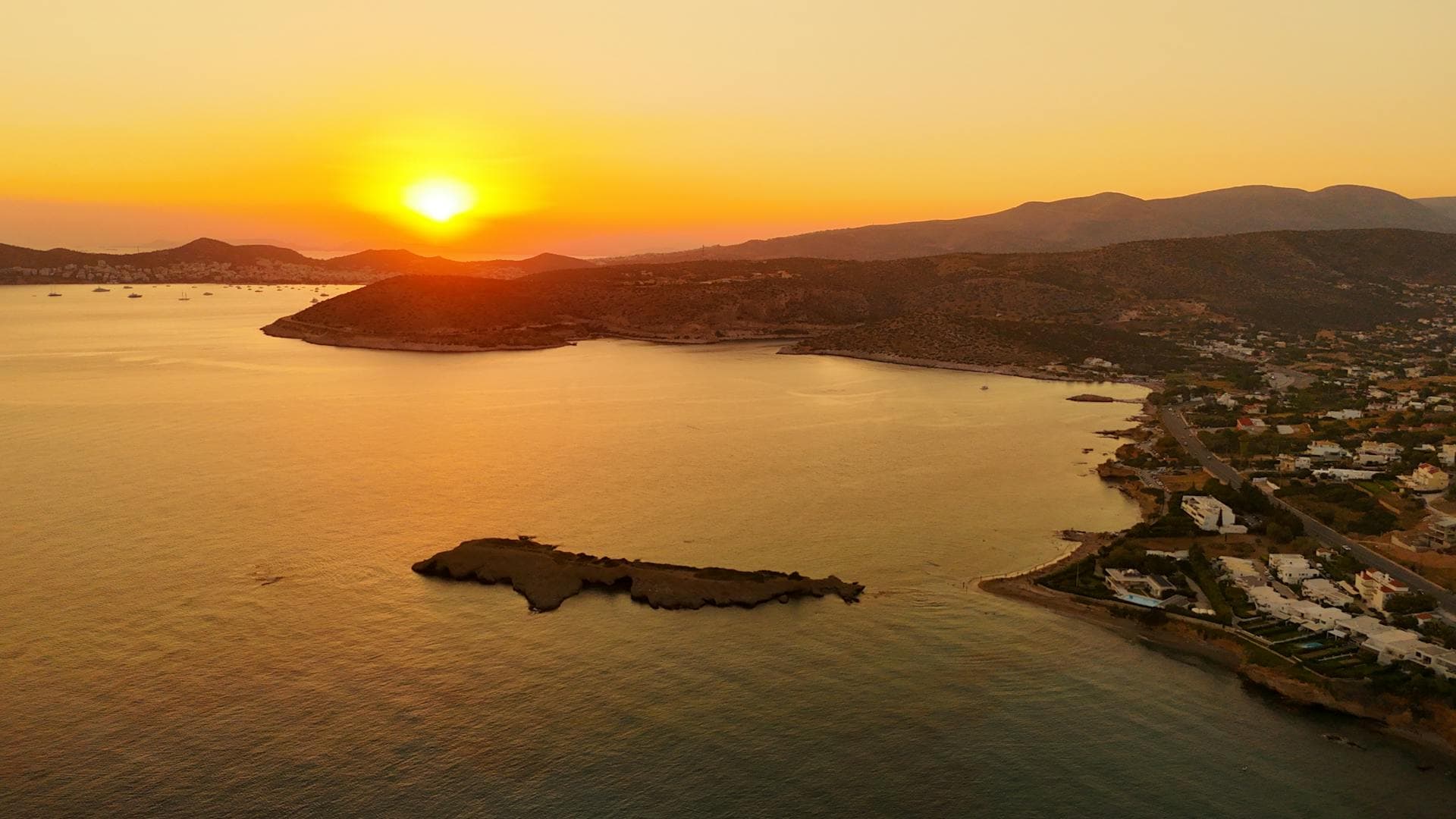 Porto Heli coastline with turquoise water and wooded hills