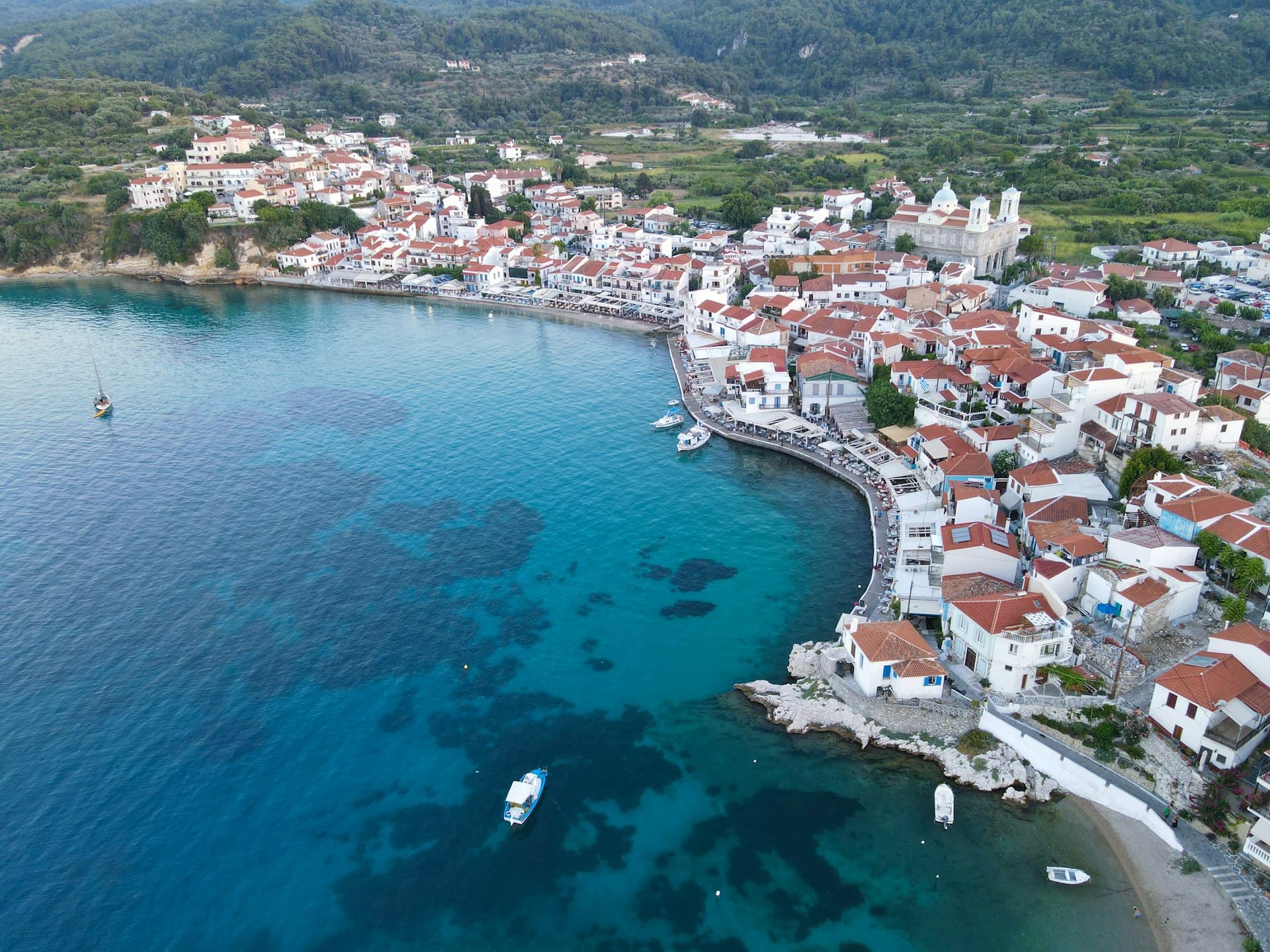 Aerial view of Spetses old harbour and pine-covered coastline